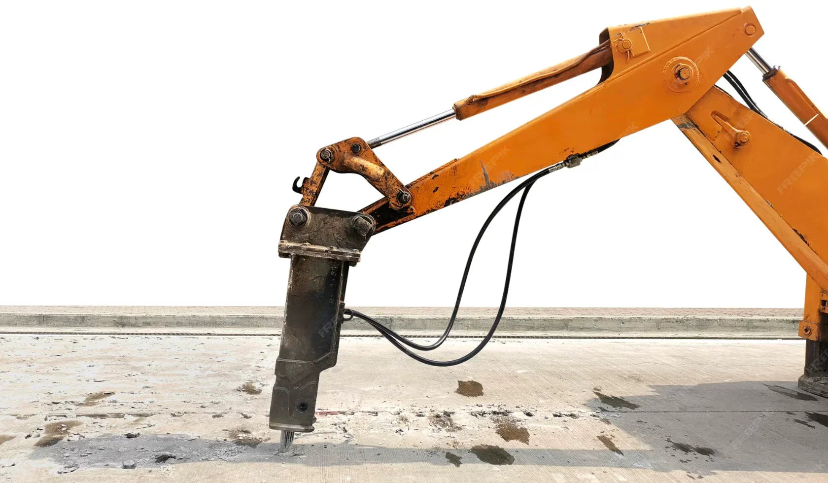 Excavator arm with hydraulic breaker attachment demolishing concrete surface